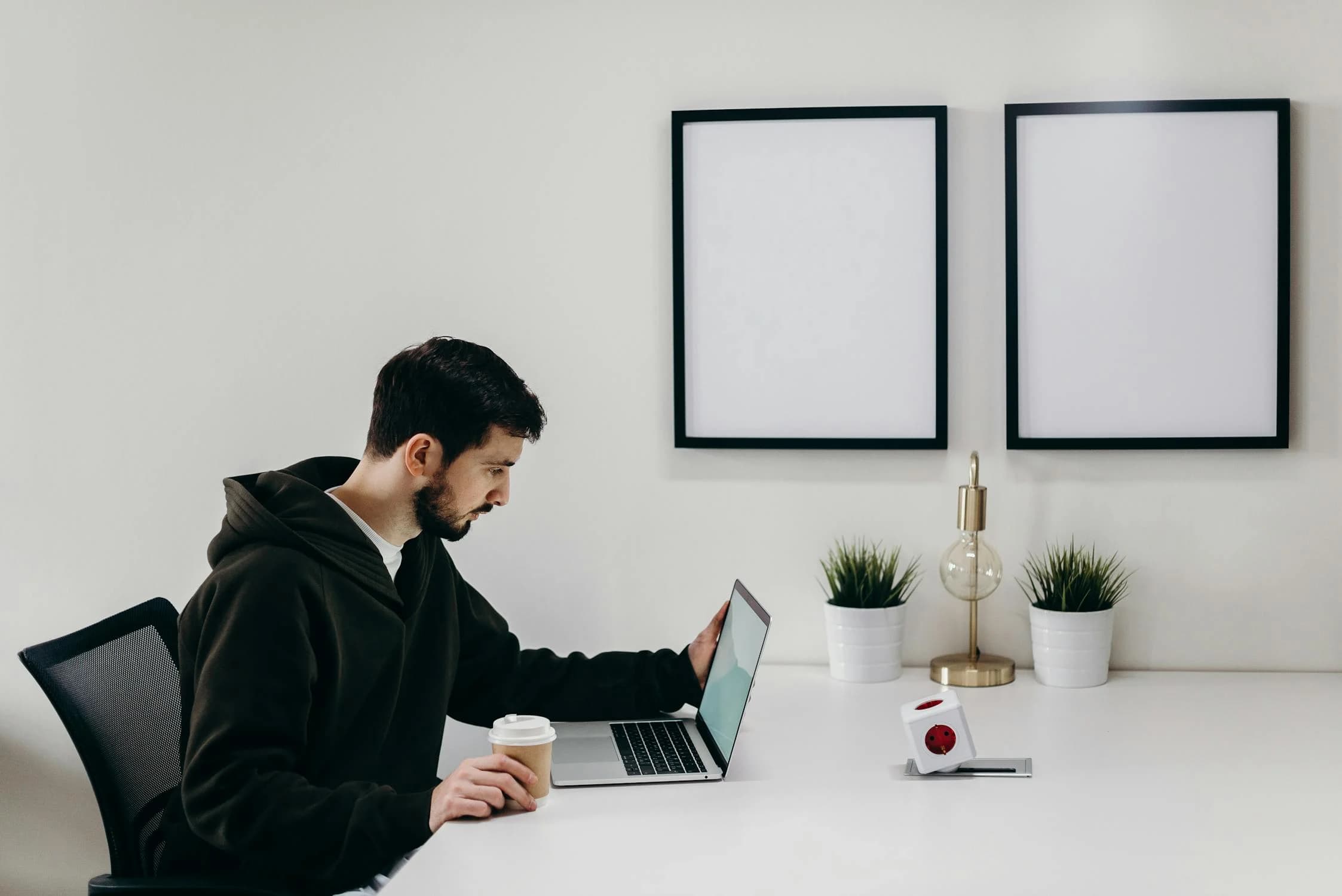 A man working on his laptop with a coffee