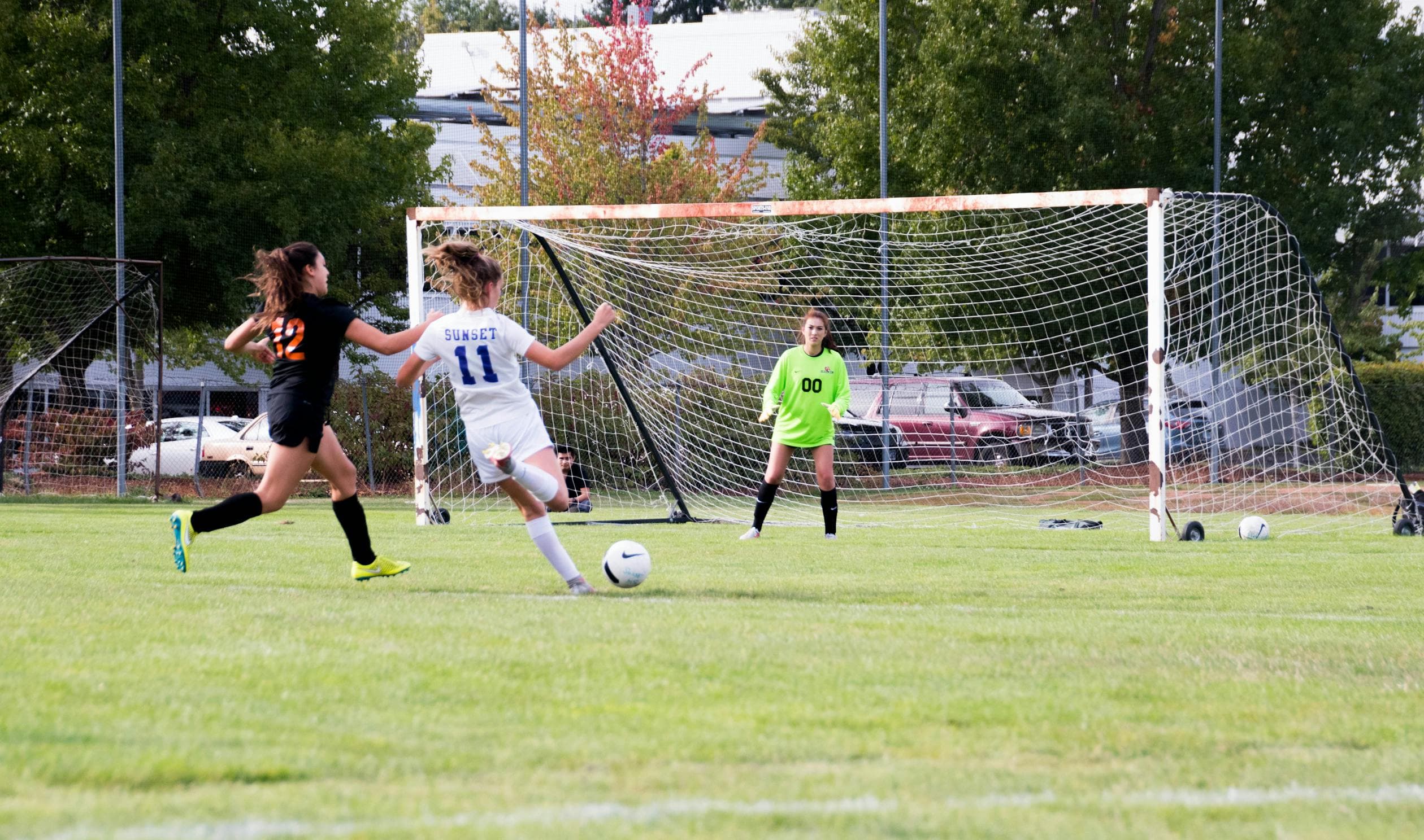 A woman scoring a goal in football