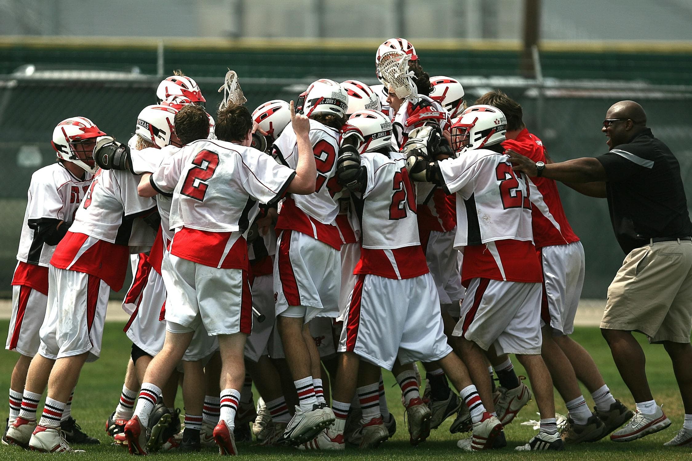 A group of American football players in a team huddle
